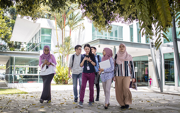 A photograph of Malaysian students on a university campus.